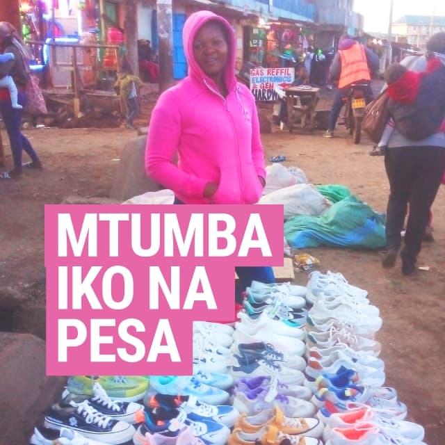 Image of a lady selling mitumba shoes