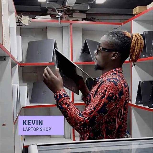 Graphic of Kevin in a laptop shop holding a laptop